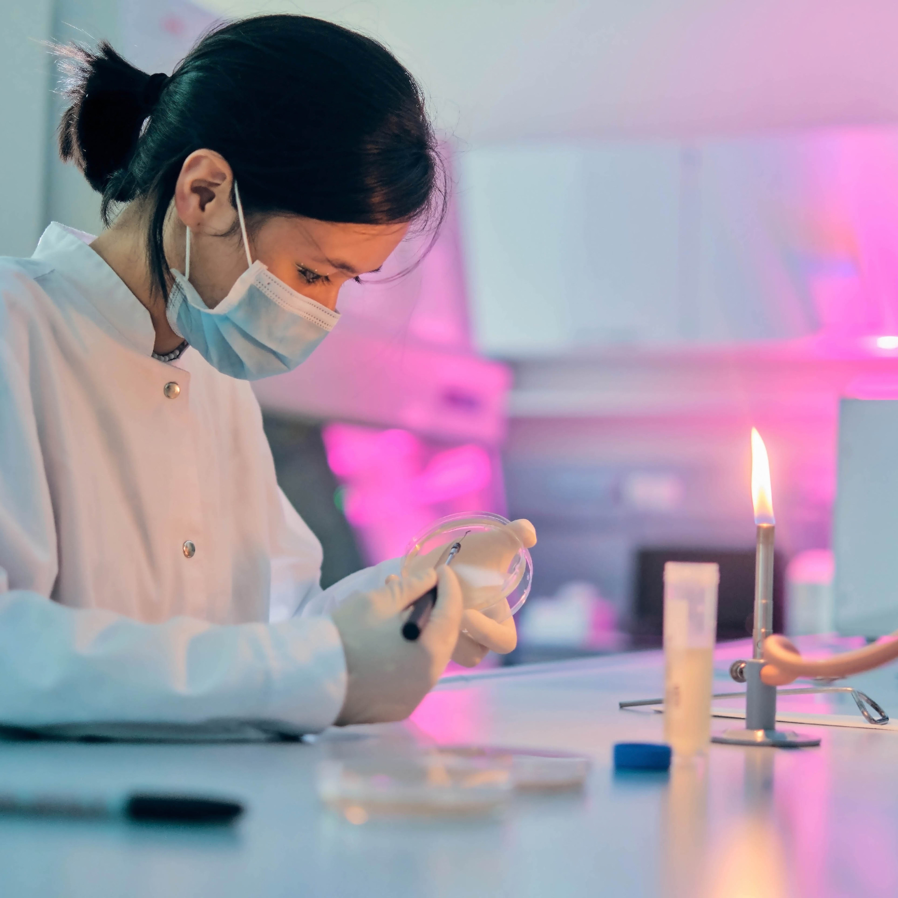 A woman performing an experiement in a lab